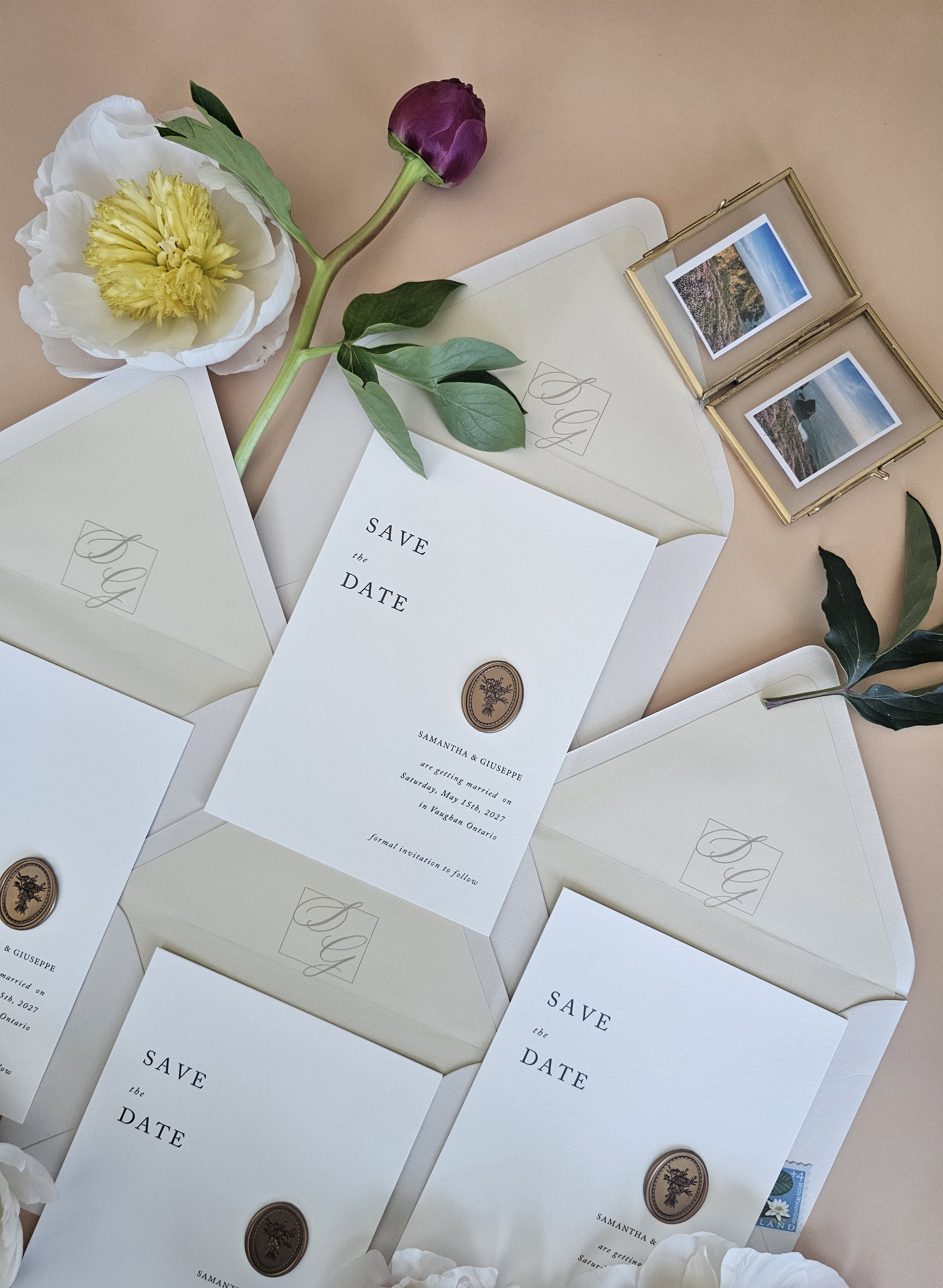 Multiple Save the Date suites styled with peonies and gold frames