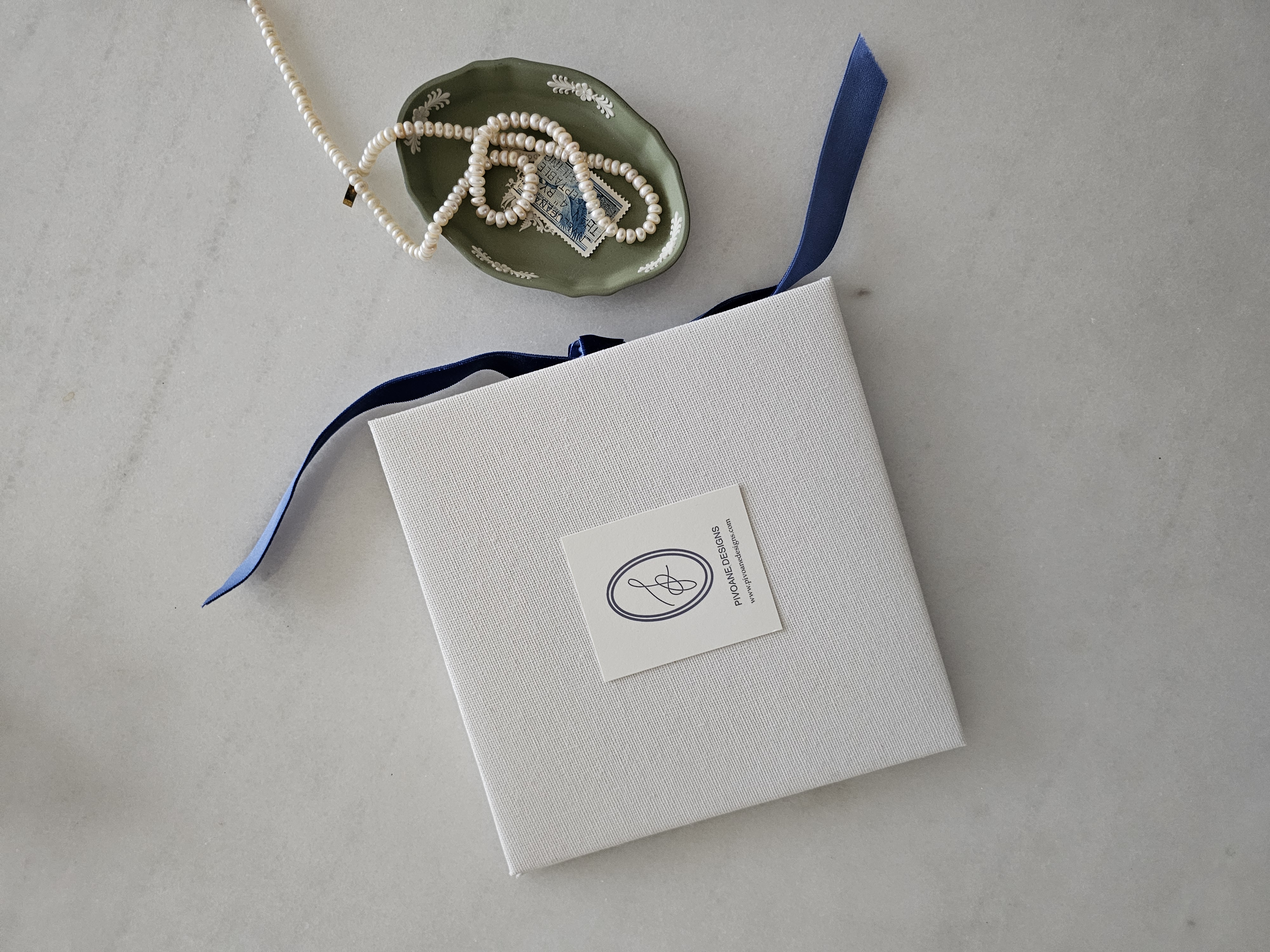 Linen keepsake portfolio box with navy silk ribbon